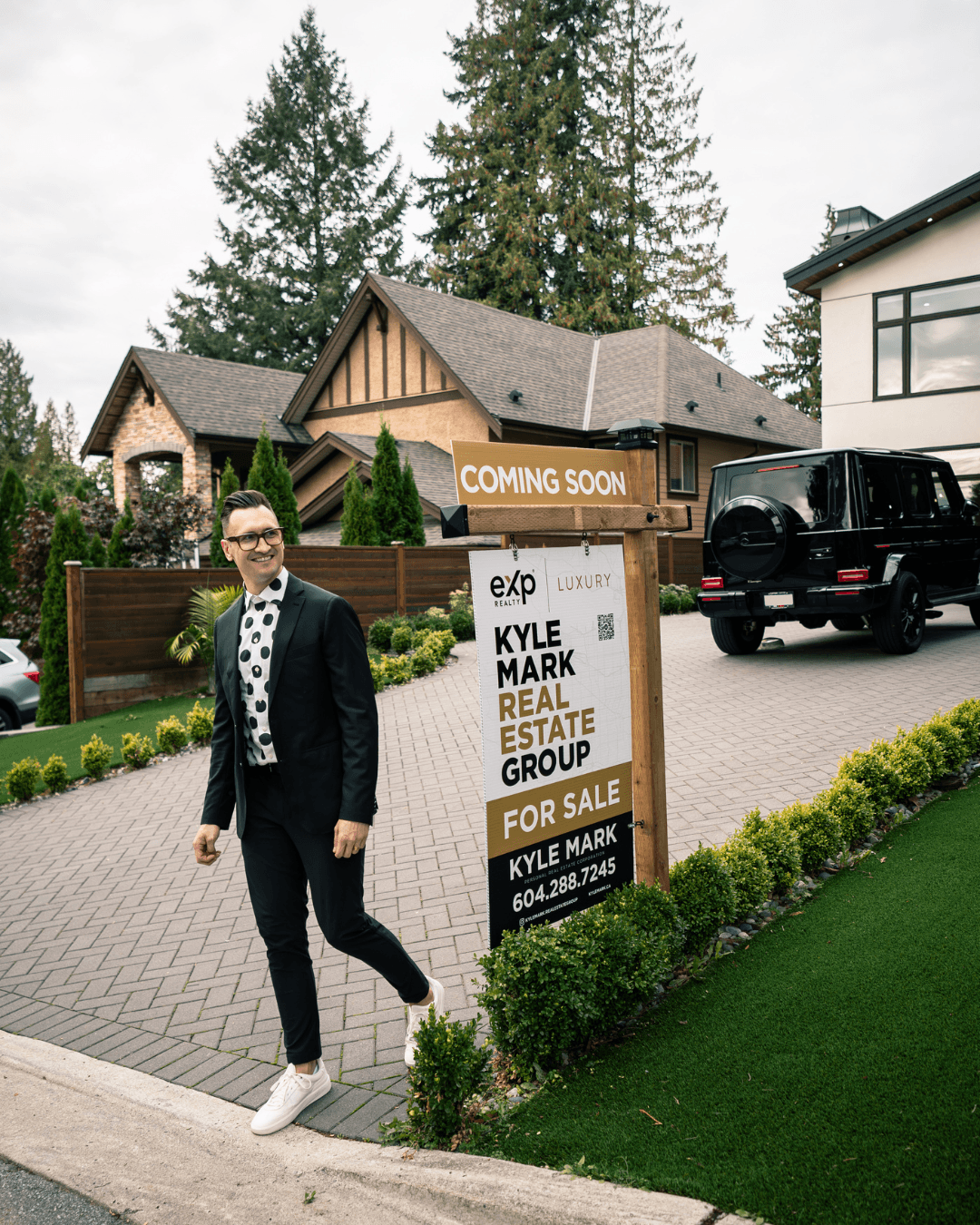 Kyle in front of a Coming Soon sign on a Vancouver listing